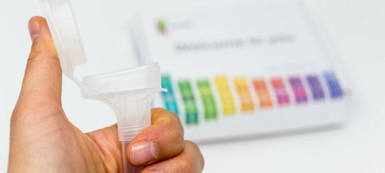 Hand holds Saliva Collection Kit Tube from 23andMe with open funnel lid to test health and ancestry with personal genetic in front of blurry background by Marco Verch https://foto.wuestenigel.com/?utm_source=46741832614&utm_campaign=FlickrDescription&utm_medium=link https://flic.kr/p/2edq7nL (CC BY 2.0)