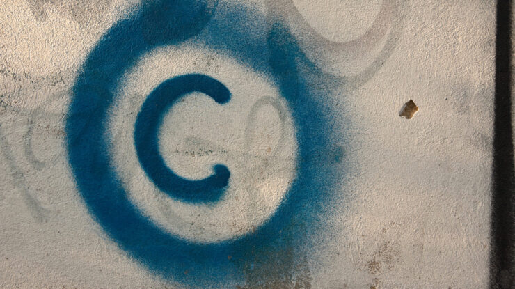 Large copyright graffiti sign on cream colored wall by Old Photo Profile (CC BY 2.0) https://flic.kr/p/7vBD4T