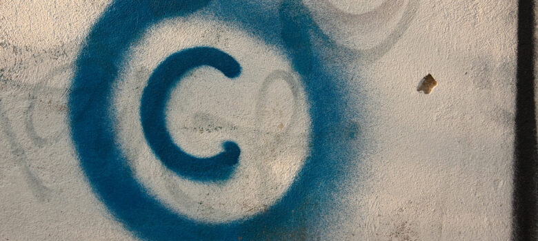 Large copyright graffiti sign on cream colored wall by Old Photo Profile (CC BY 2.0) https://flic.kr/p/7vBD4T