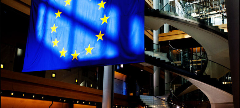 The European Union flag in the European Parliament in Strasbourg by © European Union 2013 - European Parliament. (Attribution-NonCommercial-NoDerivs Creative Commons license) https://flic.kr/p/eJxnjR