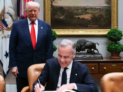 Washington, D.C., United States of America, May 6, 2025 - Prime Minister Mark Carney signs the White House guest book as President Donald J. Trump stands behind him.Photo: Lars Hagberg, https://www.pm.gc.ca/