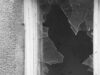 A black and white photo of a broken window Creative Commons CC0 1.0 https://picryl.com/media/broken-glass-window-446551