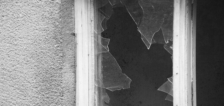 A black and white photo of a broken window Creative Commons CC0 1.0 https://picryl.com/media/broken-glass-window-446551