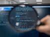 Magnifying glass over code. Photo by Kristina Alexanderson (internetstiftelsen), CC-BY-SA https://www.lawfaremedia.org/article/new-ai-transparency-rules-have-a-trade-secrets-problem