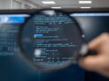 Magnifying glass over code. Photo by Kristina Alexanderson (internetstiftelsen), CC-BY-SA https://www.lawfaremedia.org/article/new-ai-transparency-rules-have-a-trade-secrets-problem