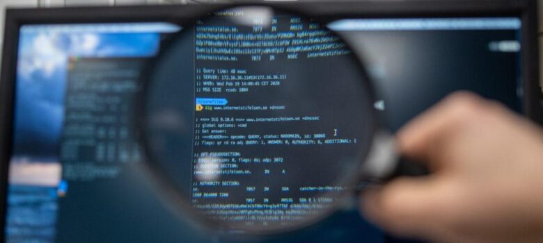 Magnifying glass over code. Photo by Kristina Alexanderson (internetstiftelsen), CC-BY-SA https://www.lawfaremedia.org/article/new-ai-transparency-rules-have-a-trade-secrets-problem