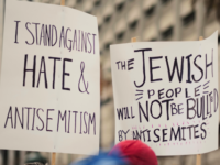 Group of people holding signs in the street by Levi Meir Clancy, Unsplash licence, https://unsplash.com/@levimeirclancy
