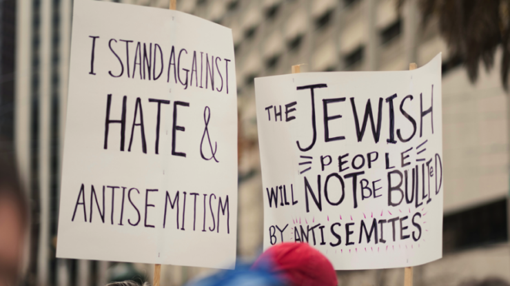 Group of people holding signs in the street by Levi Meir Clancy, Unsplash licence, https://unsplash.com/@levimeirclancy