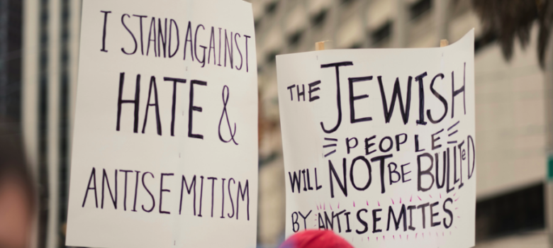 Group of people holding signs in the street by Levi Meir Clancy, Unsplash licence, https://unsplash.com/@levimeirclancy
