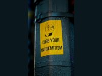 a sticker on the side of a pole that says curb your antisemitism by Jon Tyson, Unsplash licence, https://unsplash.com/photos/a-sticker-on-the-side-of-a-pole-that-says-curb-your-antisemit-iCP8fi7MX0c