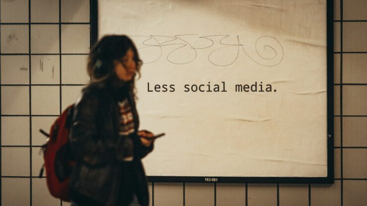 a woman standing in front of a sign that says less social media by Jon Tyson, unsplash license, https://unsplash.com/photos/a-woman-standing-in-front-of-a-sign-that-says-less-social-media-e1xl7iby_Ug