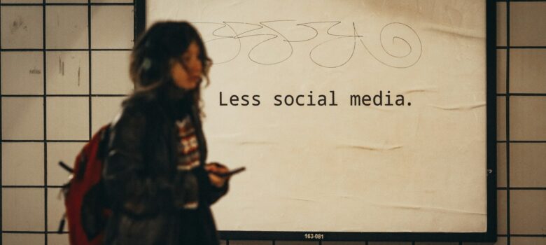 a woman standing in front of a sign that says less social media by Jon Tyson, unsplash license, https://unsplash.com/photos/a-woman-standing-in-front-of-a-sign-that-says-less-social-media-e1xl7iby_Ug